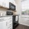 Kitchen with white cabinets and black appliances