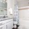 Styed bathroom with white cabinets and bathtub