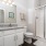 Bathroom with white cabinets and frosted shower