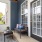 Styled balcony with large windows and blue siding